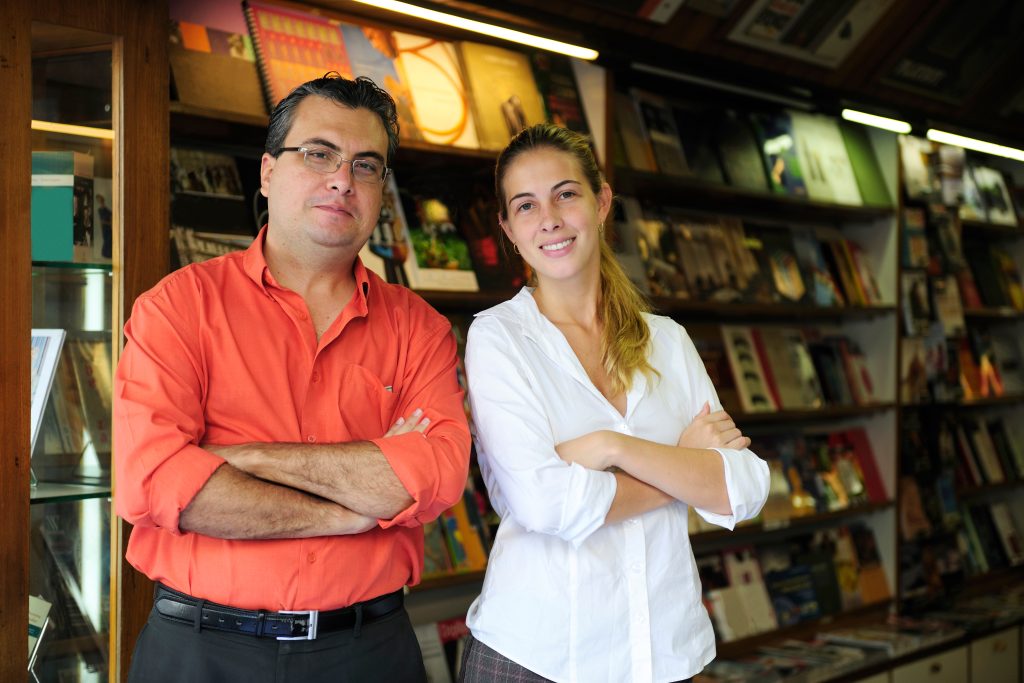 proud family business partners owners of a small bookstore. father and daughter smiling.
