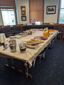 large table in conference room with a potluck lunch