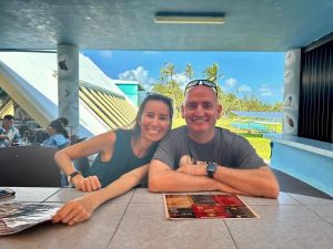 Attorney Shinju Flynn and her husband Brian are sitting at an outdoor restaurant while in Guam.