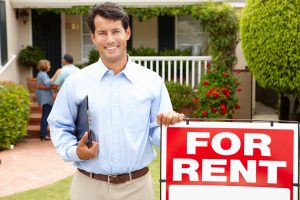 Landlord poses outside of house while showing to potential clients